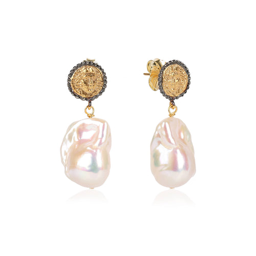 Uniquely shaped baroque pearl drops on two-tone coin posts, handmade and gold plated for an elegant touch.
