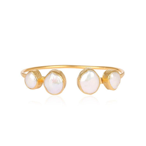 Handcrafted open bangle with four stones in textured gold, designed for comfort and perfect for stacking with other bracelets.