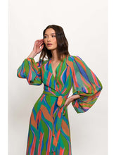 Load image into Gallery viewer, Model wearing vibrant Lindie Dress from Hutch, a colorful full sleeve maxi wrap dress with elastic wrist cuffs and exaggerated sleeves.
