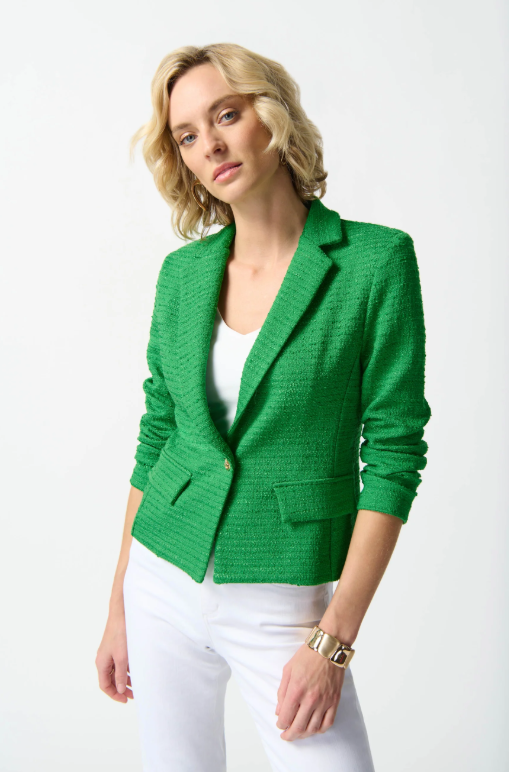 A chic bouclé blazer featuring a notched collar, tailored boxy silhouette, long sleeves, and a single button closure for elegance.