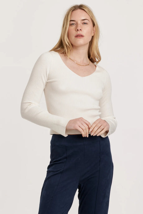 Long sleeve V-neck top in solid color, featuring a cozy ribbed texture and edge hem, perfect for versatile styling.