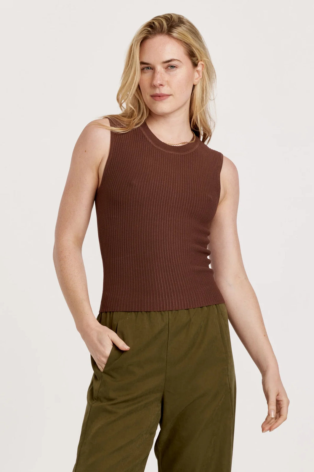 Ribbed muscle tank with high neck, sleeveless design, and woven neck band; perfect for casual comfort and adventure.