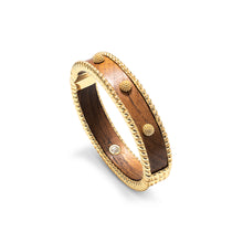 Load image into Gallery viewer, Teak cuff bracelet adorned with gold and brown beads.
