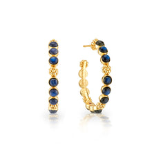 Load image into Gallery viewer, A pair of gold hoop earrings adorned with blue sapphire stones, showcasing elegance and sophistication in design.
