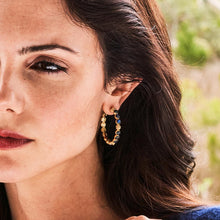 Load image into Gallery viewer, Gold hoop earrings embellished with blue sapphire stones, offering a stylish accessory for both casual and formal occasions.
