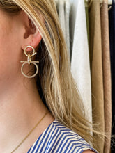 Load image into Gallery viewer, Chakarr Jewelry&#39;s Golden Knot Earrings, dangle design in hypoallergenic stainless steel, perfect for adding elegance to any outfit.
