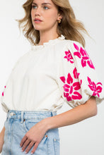 Load image into Gallery viewer, Elevate your style with the Alice Corduroy Top, featuring a white blouse adorned with pink flowers. This cozy yet fashionable top is perfect for those who dare to be bold.
