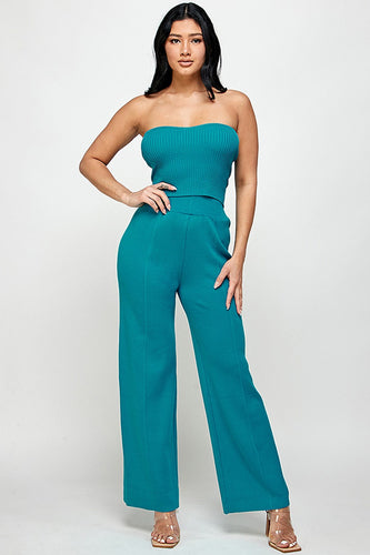 The model wears a teal tube top and matching wide-leg pants, perfect for date night.