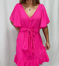 Load image into Gallery viewer, Make a statement in the Gretchen Scott Melody Dress in hot pink, complete with a modern ruffle hemline - perfect for rocking out with style!
